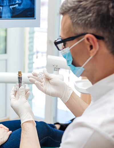 a patient and dentist chatting about dental implants