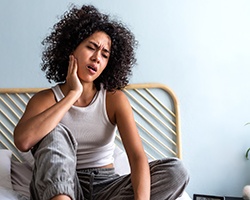 a young woman dealing with minor dental pain