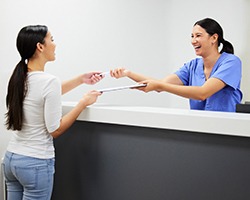 Patient in Dallas talking to dental team about financing for root canals