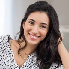 Woman with long dark hair smiling