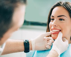 A dentist assessing his patient’s smile