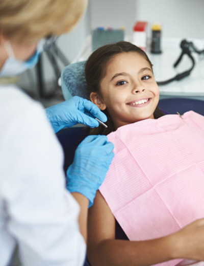 Child smiling in the dental chair