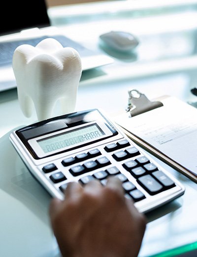 a person calculating the cost of a dental crown