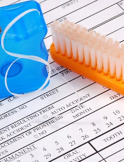 Dental insurance form, toothbrush, and floss